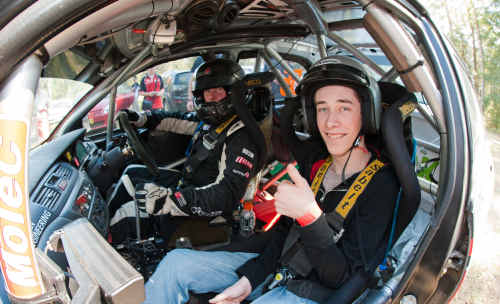 Winner of a drive in a rally car Isaac Mayhew goes for a drive with Justin Dowell. Winner of a drive in a rally car Isaac Mayhew goes for a drive with Justin Dowell.